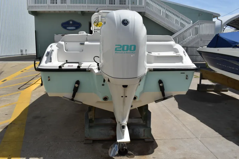 Slide: The Image of 2022 Key West 219 FS boat with Yamaha 200 outboard engine, docked outdoors. - 41