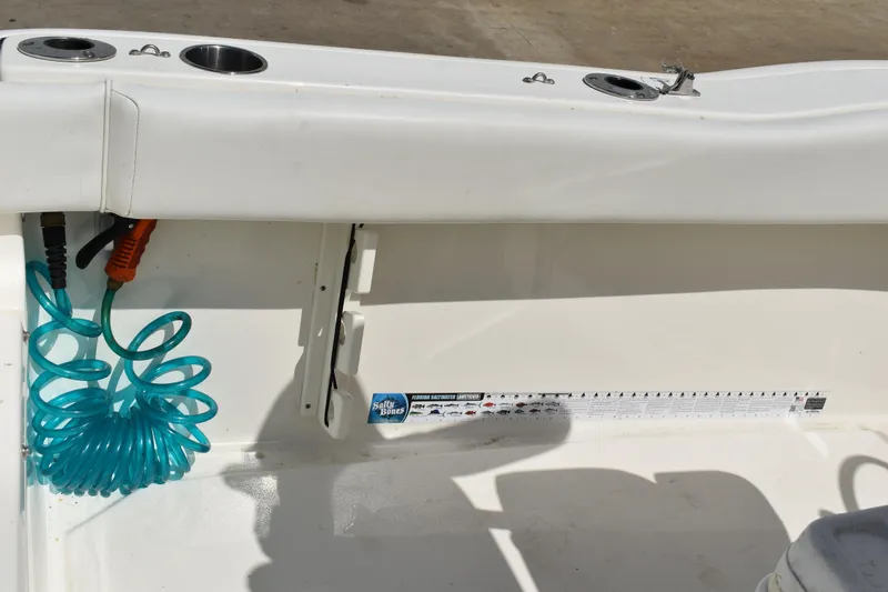 Slide: The Image of Interior of 2022 Key West 219 FS boat with coiled hose and measurement guide. - 9