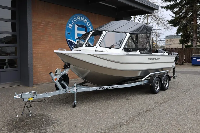 Slide: The Image of 2026 Thunder Jet 200 Luxor boat on trailer outside Bjornson Marine building. - 14