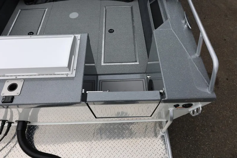 Slide: The Image of 2026 Thunder Jet 200 Luxor boat interior with storage compartments and metallic finish. - 19