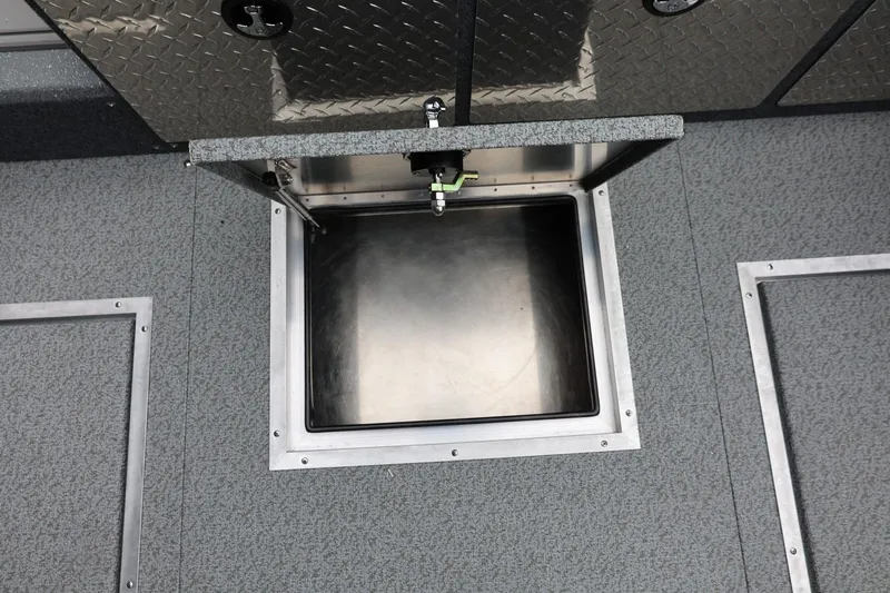 Slide: The Image of Open storage compartment on 2026 Thunder Jet 200 Luxor boat, featuring diamond plate design. - 25