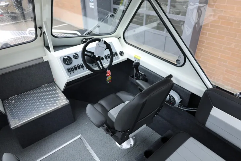 Slide: The Image of Interior of 2026 Thunder Jet 200 Luxor boat with modern steering and seating. - 32