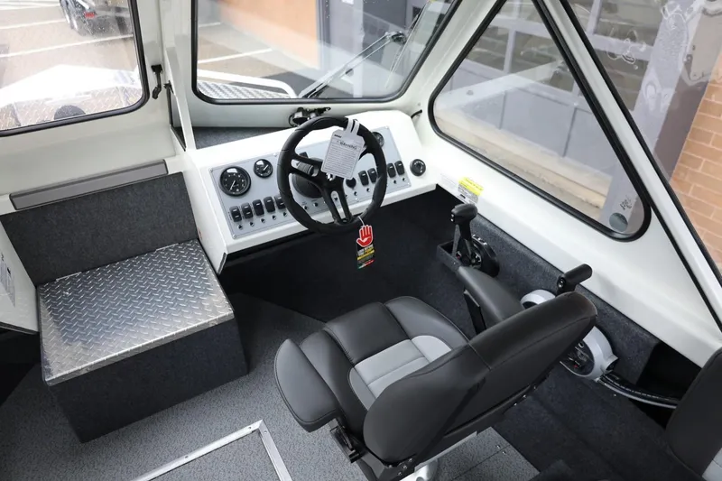 Slide: The Image of Interior of 2026 Thunder Jet 200 Luxor boat, featuring steering wheel and control panel. - 35