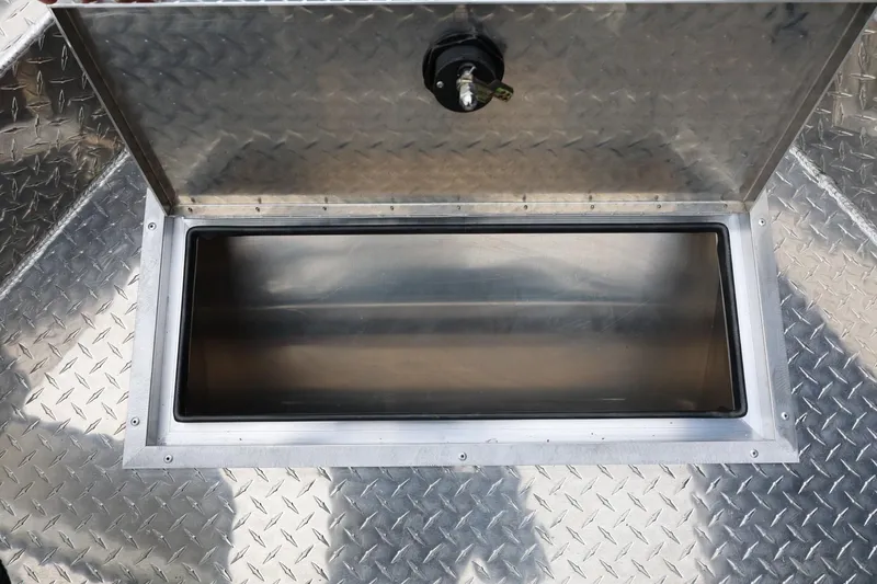 Slide: The Image of Open storage compartment on 2026 Thunder Jet 200 Luxor boat with diamond plate flooring. - 49