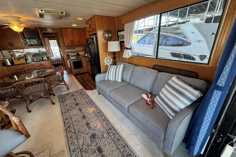 Slide: The Image of Interior of 1987 Stardust Cruisers houseboat with cozy living area and kitchen. - 10