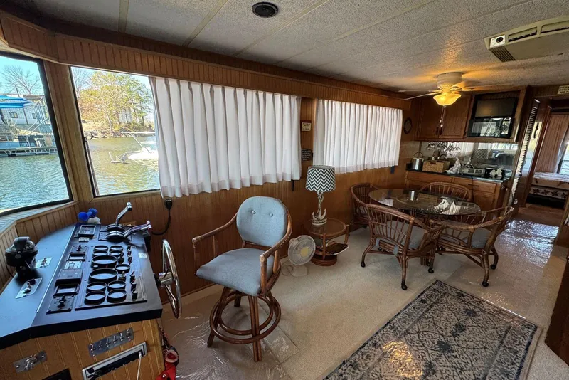Slide: The Image of Interior of a 1987 Stardust Cruisers 14 x 54 houseboat with dining area and helm. - 11
