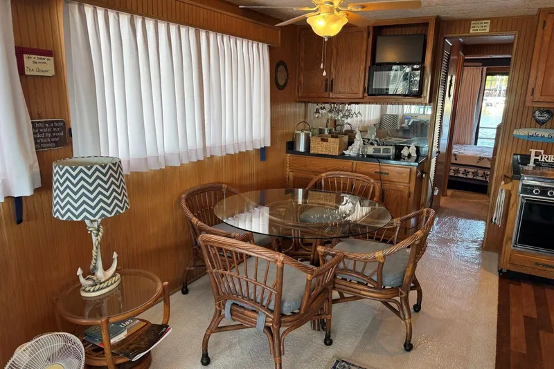 Slide: The Image of Interior of a 1987 Stardust Cruisers houseboat with dining area and kitchen. - 12