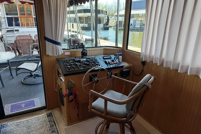 Slide: The Image of Interior view of 1987 Stardust Cruisers 14 x 54 houseboat helm with steering wheel and controls. - 13