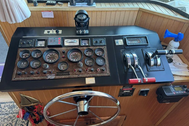 Slide: The Image of Control panel of a 1987 Stardust Cruisers 14 x 54 houseboat with gauges and steering wheel. - 14