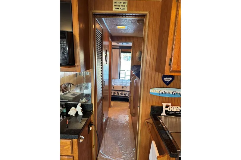 Slide: The Image of Interior of 1987 Stardust Cruisers 14 x 54 houseboat with wood paneling and cozy decor. - 20