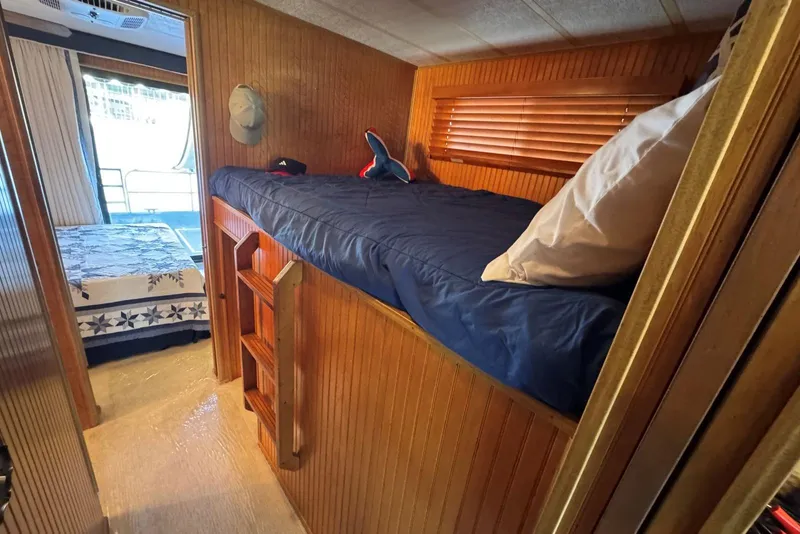 Slide: The Image of 1987 Stardust Cruisers 14 x 54 interior with cozy bunk bed and wooden paneling. - 22
