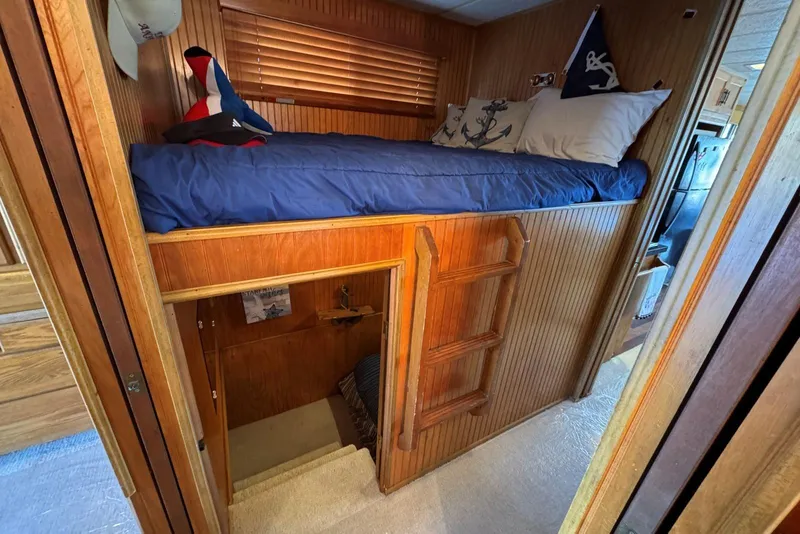 Slide: The Image of Cozy wooden bunk bed area in 1987 Stardust Cruisers houseboat interior. - 24