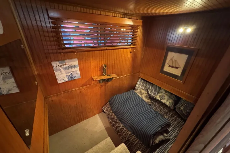 Slide: The Image of Cozy cabin interior of 1987 Stardust Cruisers houseboat with nautical decor and wooden paneling. - 25
