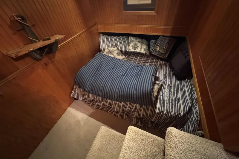 Slide: The Image of Cozy bedroom in 1987 Stardust Cruisers houseboat with striped bedding and wooden walls. - 26