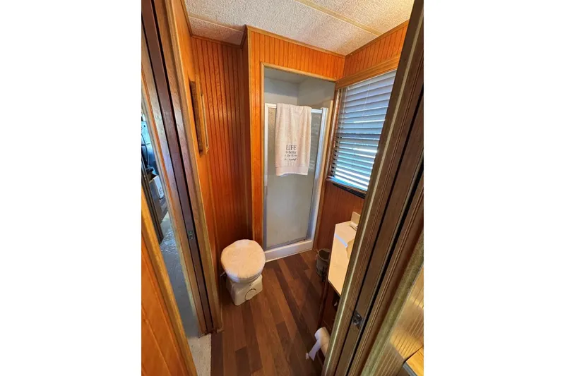 Slide: The Image of Bathroom interior of 1987 Stardust Cruisers 14 x 54 houseboat with wood paneling. - 35