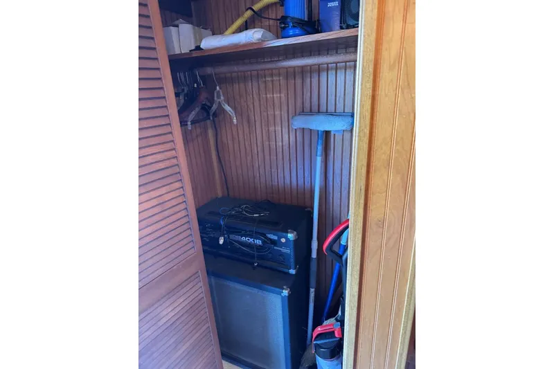 Slide: The Image of Wooden closet with cleaning supplies and audio equipment on a 1987 Stardust Cruisers 14 x 54. - 37
