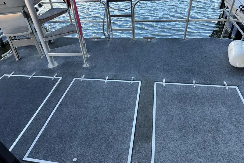 Slide: The Image of 1987 Stardust Cruisers 14 x 54 boat deck with carpet and stairs, overlooking water. - 38