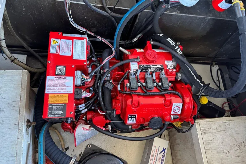 Slide: The Image of Engine compartment of a 1987 Stardust Cruisers 14 x 54 houseboat, featuring a red engine. - 43