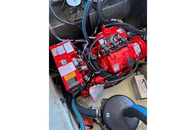 Slide: The Image of Red engine in a 1987 Stardust Cruisers 14 x 54 boat, surrounded by cables and components. - 44