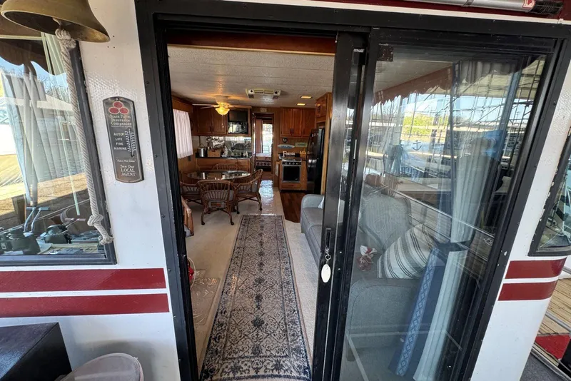 Slide: The Image of Interior view of a 1987 Stardust Cruisers 14 x 54 houseboat with cozy furnishings. - 8