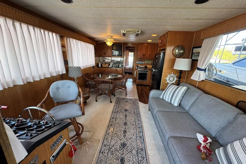 Slide: The Image of Interior of 1987 Stardust Cruisers houseboat with cozy seating and dining area. - 9