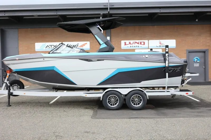 The Image of 2026 Tigé Z3 boat on trailer, featuring sleek design with blue and gray accents. - 1