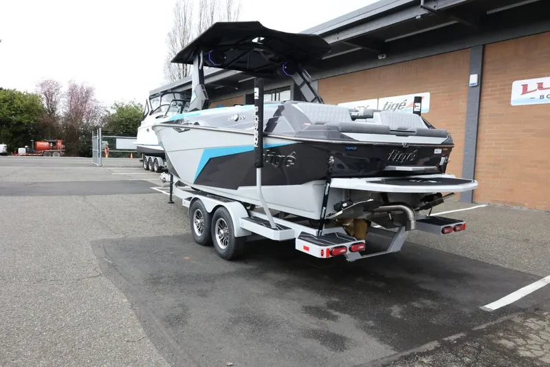 Slide: The Image of 2026 Tigé Z3 boat on trailer, parked outdoors near a building. - 10