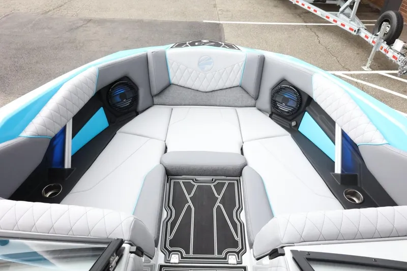 Slide: The Image of 2026 Tigé Z3 boat interior with blue and gray seating, cup holders, and speakers. - 18