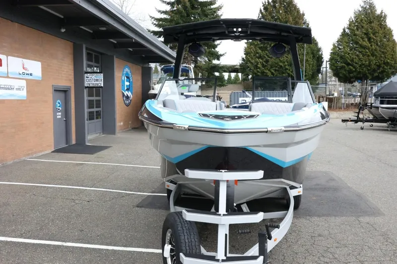 Slide: The Image of 2026 Tigé Z3 boat on trailer outside dealership, showcasing sleek design and modern features. - 4