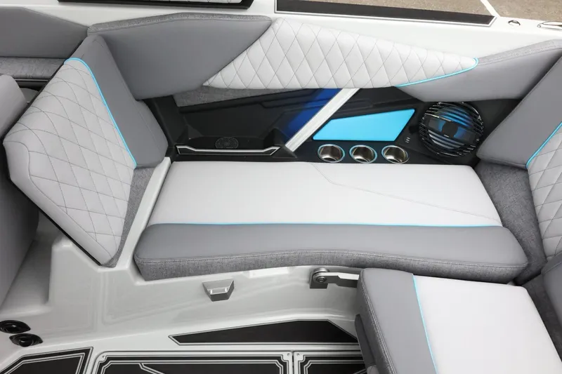 Slide: The Image of 2026 Tigé Z3 boat interior with gray and blue seating, cup holders, and speaker. - 41