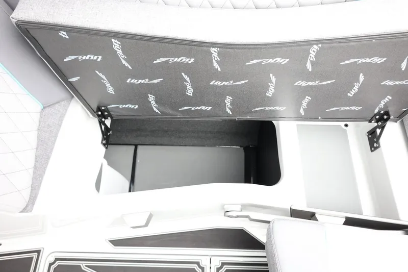 Slide: The Image of 2026 Tigé Z3 boat interior storage compartment with open seat cushion. - 42