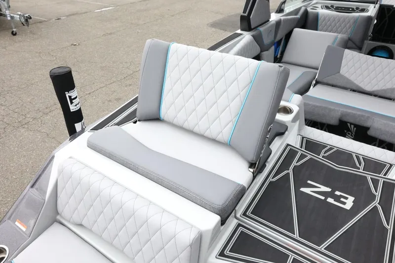 Slide: The Image of 2026 Tigé Z3 boat interior with stylish gray and blue seating and Z3 logo flooring. - 47