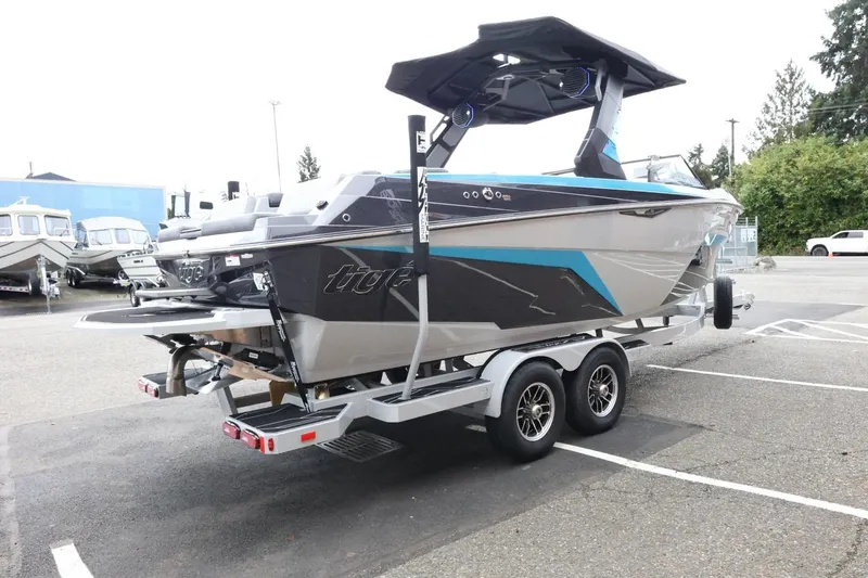 Slide: The Image of 2026 Tigé Z3 boat on trailer in parking lot, showcasing sleek design and modern features. - 8