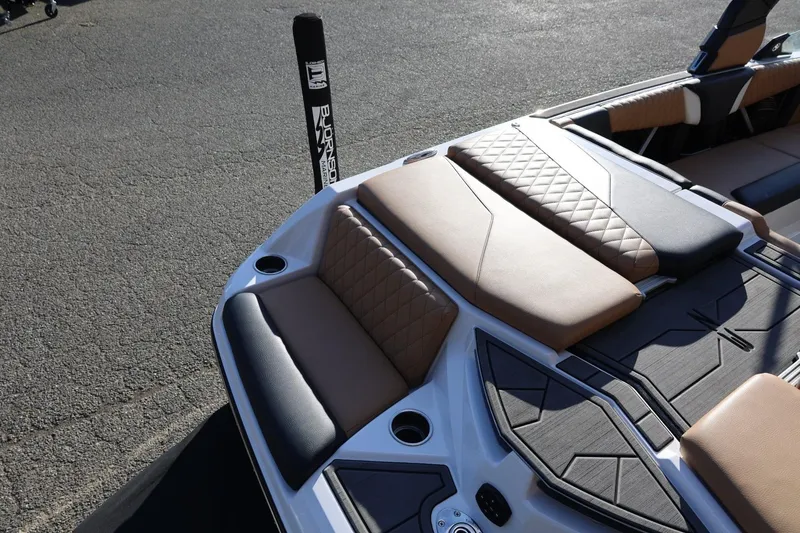 Slide: The Image of 2023 Tigé Z3 boat interior with tan and black seating, diamond stitching, and cup holders. - 16