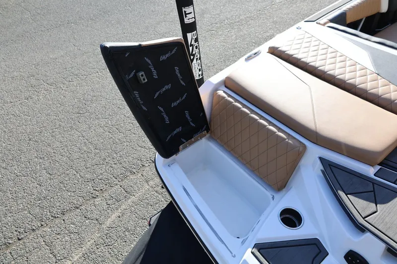 Slide: The Image of 2023 Tigé Z3 boat with open storage compartment and tan quilted seating. - 18