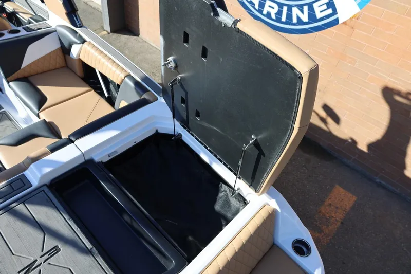 Slide: The Image of 2023 Tigé Z3 boat interior with open storage compartment and tan seating. - 22