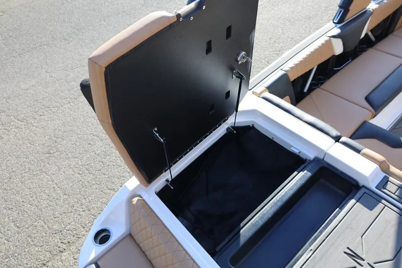 Slide: The Image of 2023 Tigé Z3 boat interior storage compartment with open lid and cushioned seating. - 23