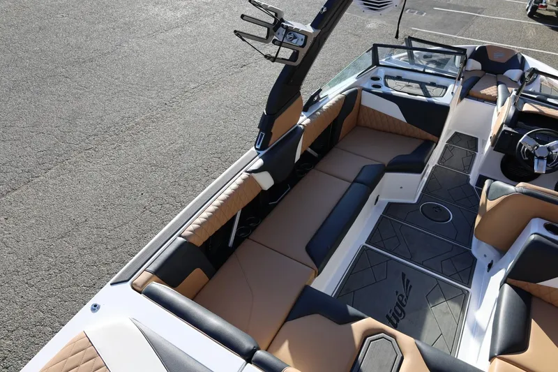 Slide: The Image of 2023 Tigé Z3 boat interior with tan and black seating, modern design. - 25