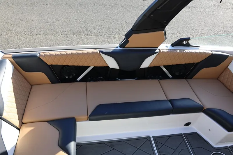 Slide: The Image of 2023 Tigé Z3 boat interior with tan and black quilted seating. - 27