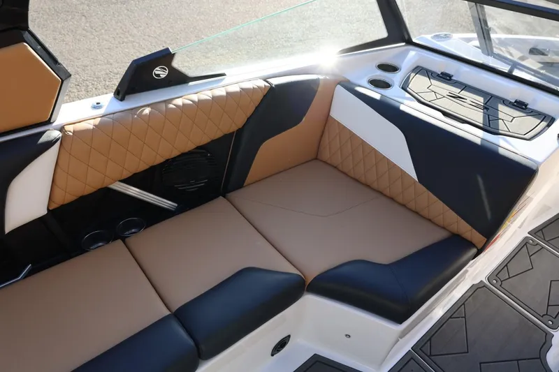 Slide: The Image of 2023 Tigé Z3 boat interior with tan and black quilted seating. - 28