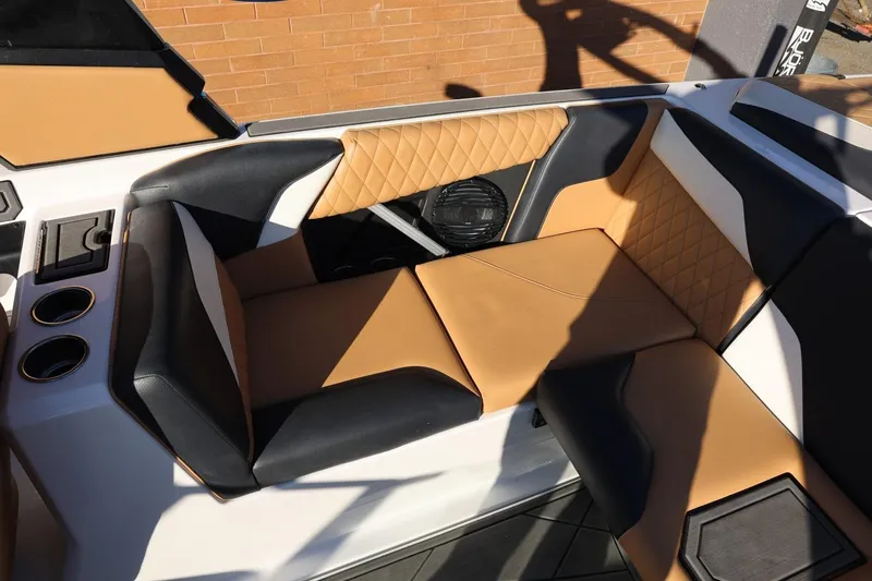 Slide: The Image of 2023 Tigé Z3 boat interior with tan and black quilted seating. - 29