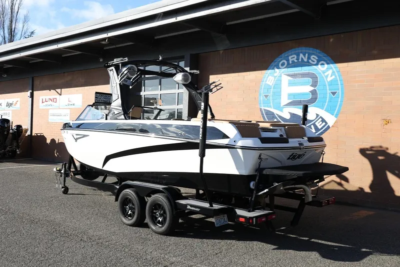 Slide: The Image of 2023 Tigé Z3 boat on trailer outside Bjornson Marine building. - 3