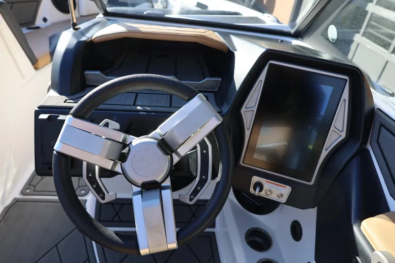 Slide: The Image of 2023 Tigé Z3 boat dashboard with modern steering wheel and touchscreen display. - 32