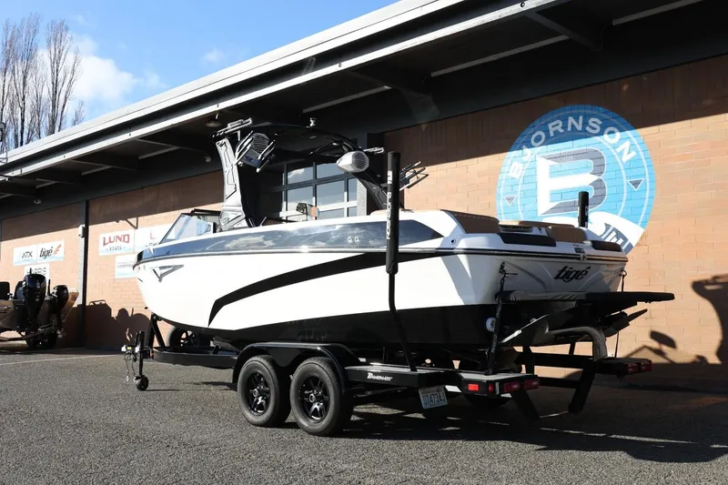 Slide: The Image of 2023 Tigé Z3 boat on trailer outside dealership, showcasing sleek design and modern features. - 4