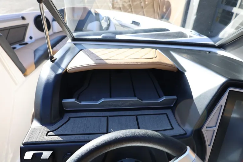 Slide: The Image of 2023 Tigé Z3 boat dashboard with steering wheel and storage compartments. - 40
