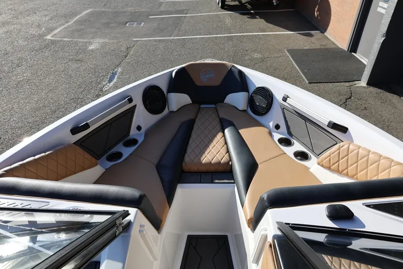 Slide: The Image of 2023 Tigé Z3 boat interior with tan and black seating, cup holders, and speakers. - 42