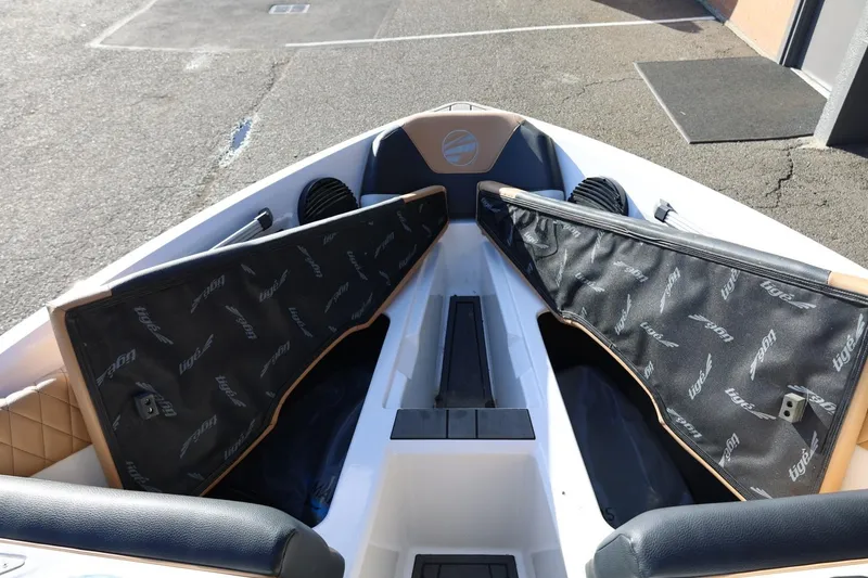 Slide: The Image of 2023 Tigé Z3 boat interior with open storage compartments and branded covers. - 45