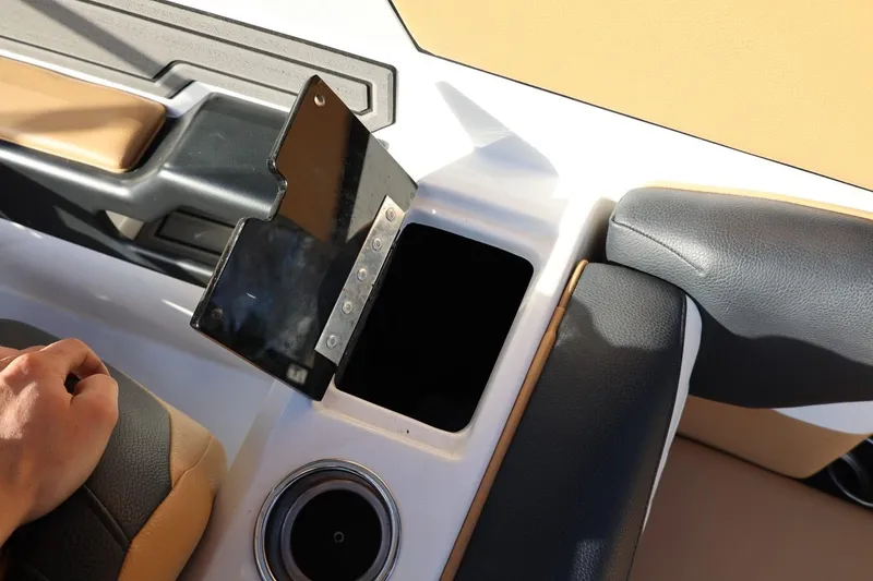 Slide: The Image of 2023 Tigé Z3 boat interior with open storage compartment and cup holder. - 53