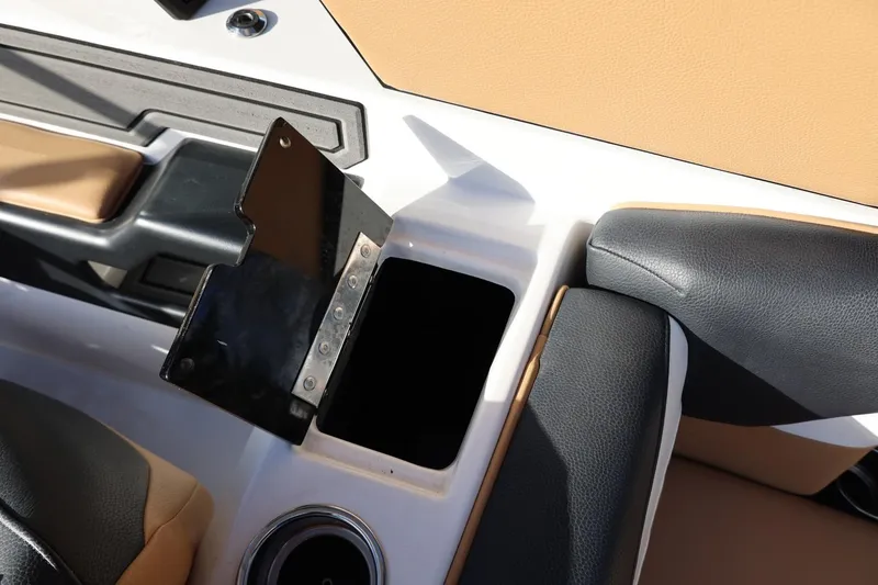 Slide: The Image of 2023 Tigé Z3 boat interior with open storage compartment and cup holder. - 54