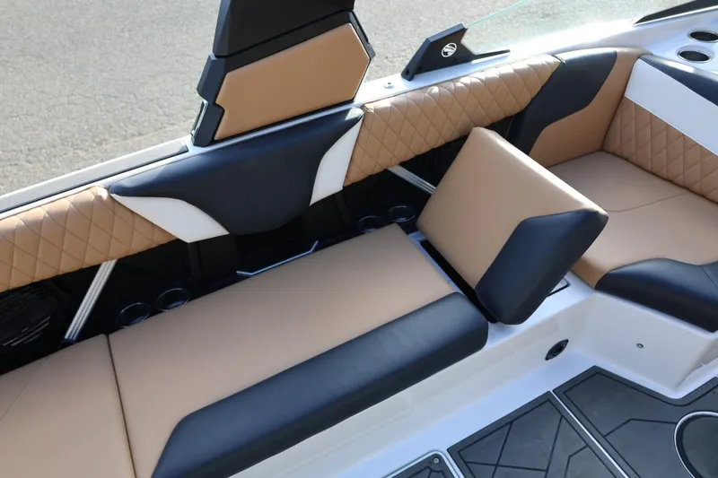 Slide: The Image of 2023 Tigé Z3 boat interior with tan and black seating, featuring quilted upholstery design. - 56